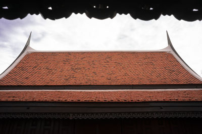 Low angle view of building roof against sky