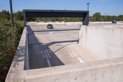 Empty road against built structure