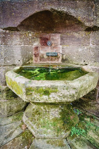 Close-up of water fountain against wall