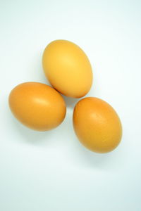 Close-up of yellow eggs against white background