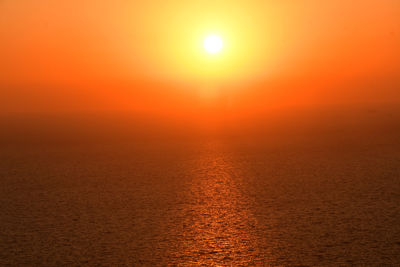 Scenic view of sunset against orange sky