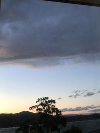 Scenic view of silhouette mountain against sky at sunset