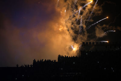High angle view of firework display at night
