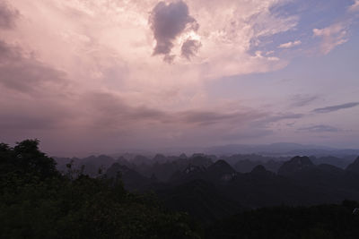 Scenic view of silhouette mountains against sky at sunset