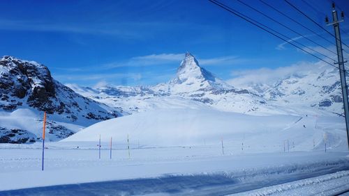 Scenic view of snow covered mountains against sky