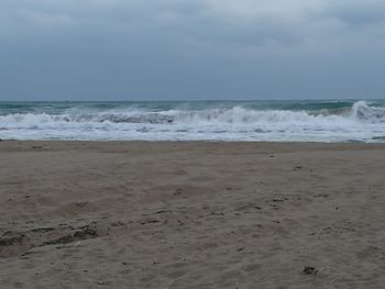 Scenic view of beach and sea against sky