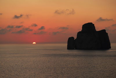 Scenic view of sea against orange sky