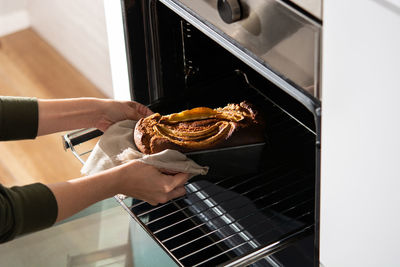 Midsection of person preparing food at home