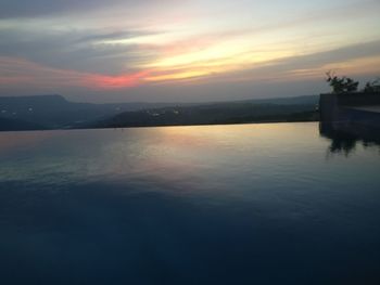 Scenic view of lake against sky during sunset