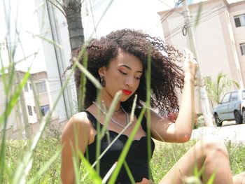 Portrait of young woman looking away outdoors