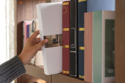 Close-up of hand holding open book