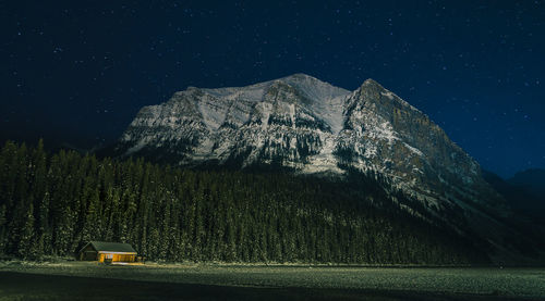 Scenic view of mountains against sky at night