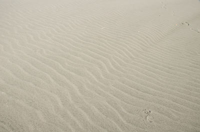 High angle view of footprints on sand at beach