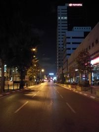 Illuminated city street at night