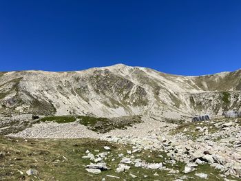 Scenic view of mountains against clear blue sky