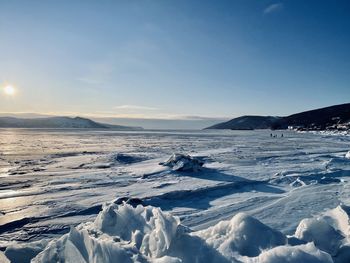 Scenic view of snowcapped mountains against sky during winter