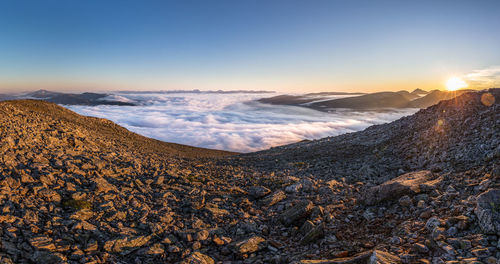 Idyllic shot of mountains in foggy weather against sky