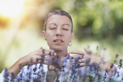 Woman smelling lavender flowers