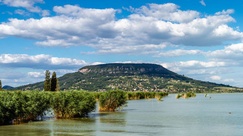 Scenic view of lake and mountains against sky