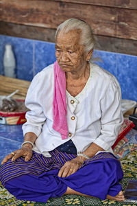 Full length of woman sitting on seat