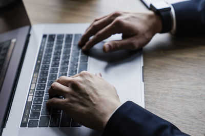 High angle view of man using laptop on table