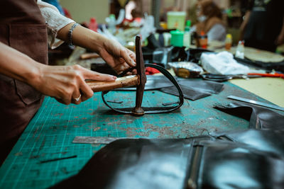 Midsection of man working at workshop