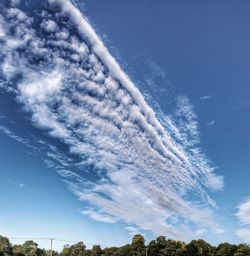 Low angle view of vapor trail against blue sky