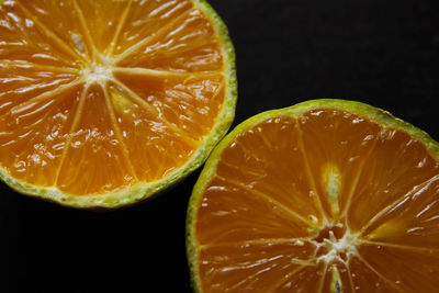 Close-up of orange slice against black background