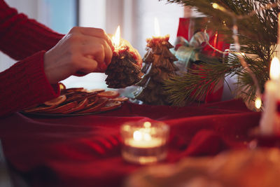 Person lighting christmas candles at home