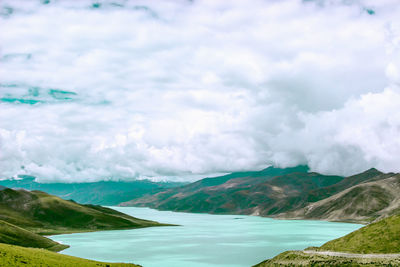 Scenic view of sea and mountains against sky