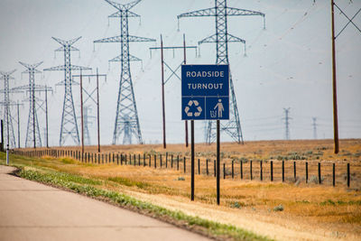 Information sign on road by electricity pylon