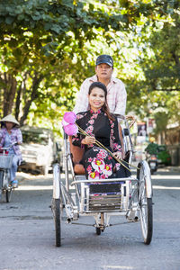 Woman sitting on a rickshaw in hue / vietnam