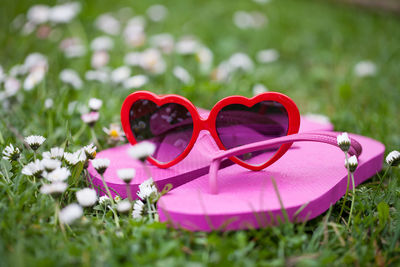 Close-up of heart shape sunglasses on grass