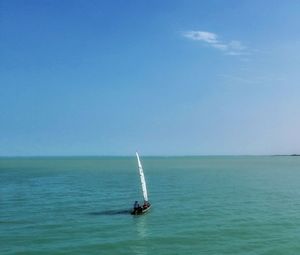 Sailboat in sea against sky