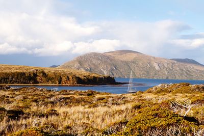 Scenic view of sea and mountains against sky