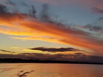 Scenic view of dramatic sky over sea during sunset