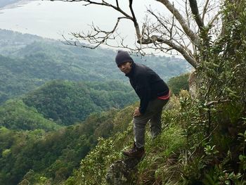 Man with arms outstretched on mountain