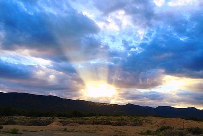 Scenic view of dramatic sky over mountains