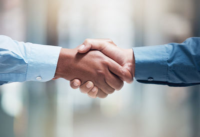 Cropped image of couple holding hands