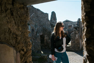 Woman standing at historical building