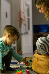 Mother and son playing a game at home