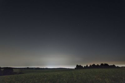 Scenic view of field against clear sky at night