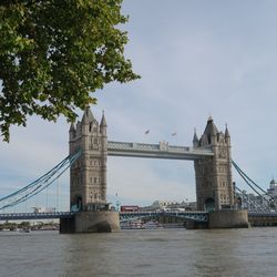 Low angle view of suspension bridge over river