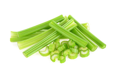 Close-up of green chili pepper against white background