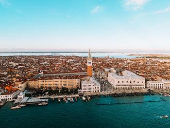 High angle view of townscape by sea against sky