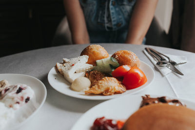 Close-up of person preparing food in plate