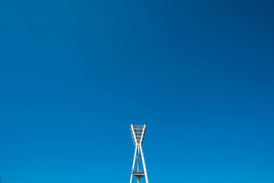 Low angle view of floodlight against clear blue sky