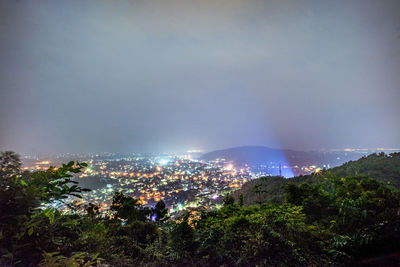 High angle view of illuminated buildings against sky at night