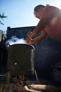 Woman preparing food outdoors