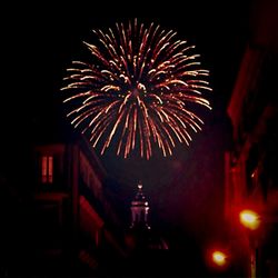 Low angle view of firework display at night